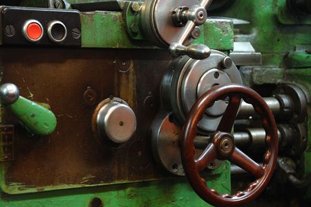 old industrial tool with a lot of wheels and buttonsの写真素材