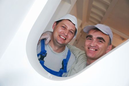 two smiling middle-aged construction workers at workの写真素材