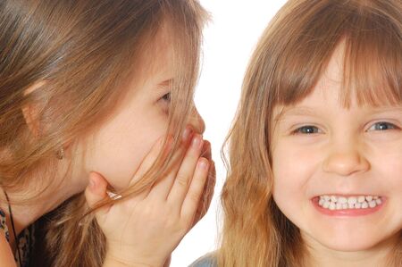 two little girls having a secret funny chat