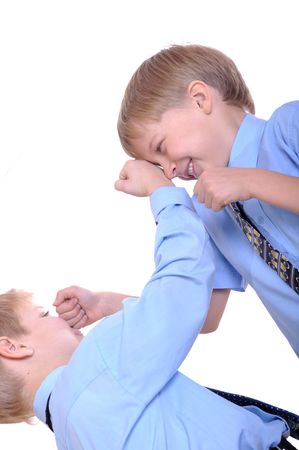 Two schoolboys fighting. Isolated over white.