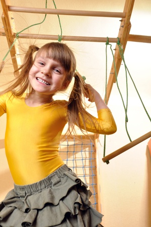 6 year old girl  playing at her home wooden gymの写真素材