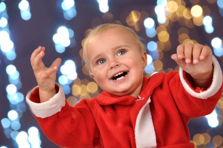 beautiful happy baby with raised handsの写真素材