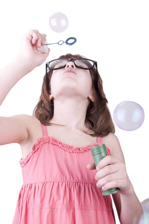 Child blowing soap bubbles  Isolated over white の写真素材