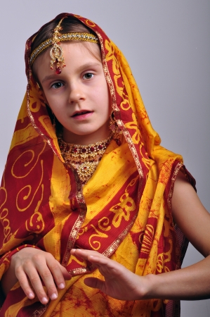 portrait of a little girl in traditional Indian clothing and jeweleriesの写真素材