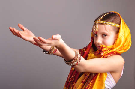 portrait of a little girl in traditional Indian clothing, sari and jeweleriesの写真素材