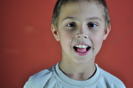 Portrait of excited small boy. Hard light.