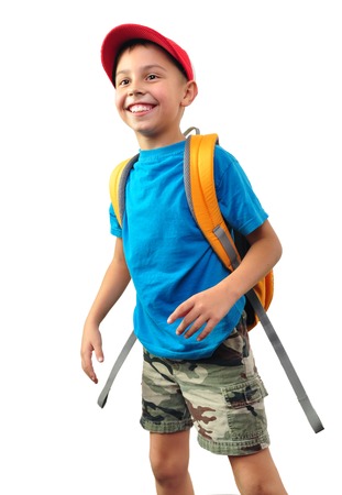 Portrait of a cute little schoolchild with backpack and a cap. Isolated over white background.の写真素材