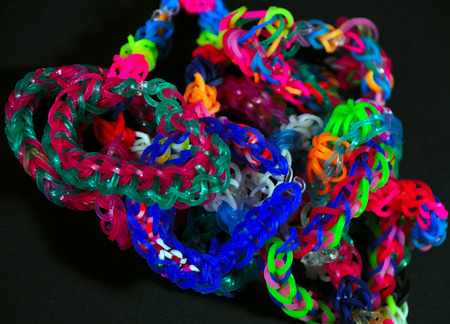 colorful background rainbow colors rubber bands loom bracelets on black background