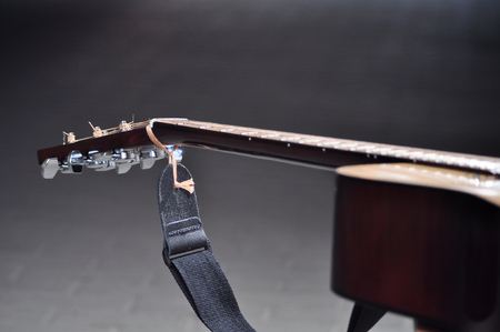 the classic acoustic guitar agaist dark backgroundの写真素材
