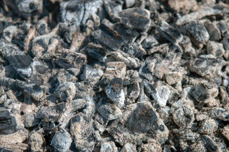 The texture of hot ash, gray, on the grill