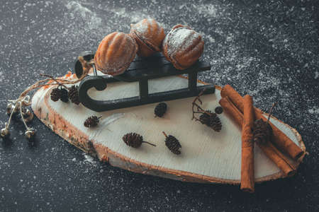 New Year's still life with nuts on a sleigh with cinnamon