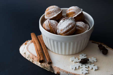 New Year's nuts with condensed milk and cinnamon, with a snowflake on a black background