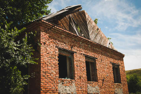 Old ruined red brick building with empty windowsの写真素材