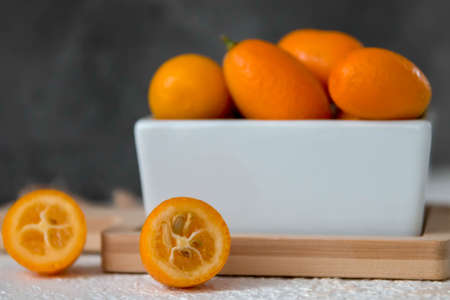 Kumquat in a cup on a pink backgroundの写真素材