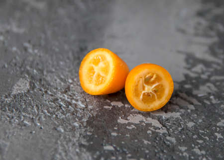 Kumquat fruit cut on the tableの写真素材