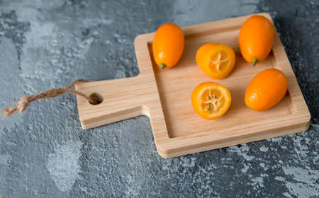 Fruit kumquat against a grey concrete backgroundの写真素材