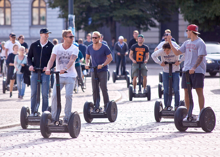STOCKHOLM, SWEDEN - SEPTEMBER 6, 2014. A group of happy young men on Segways in the middle of Stockholm; capital of Swedenのeditorial素材