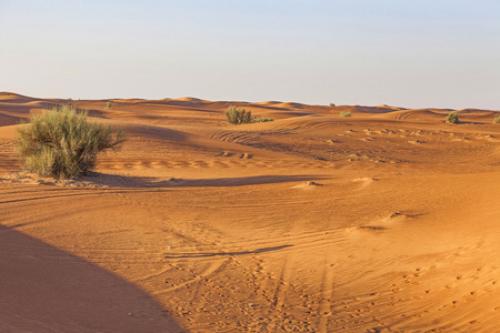 Dubai, UAE - Oct 20, 2016. Man walking in desert.の写真素材