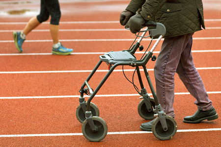 Stockholm, Sweden - May 15, 2016. Man with a walker on a racetrack.のeditorial素材