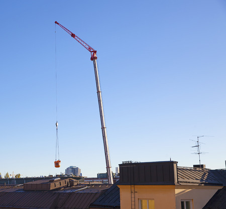 Stockholm, Sweden - July 17, 2016. Crane and roof tops.のeditorial素材