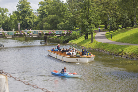 Gothenburg, Sweden - August 10, 2016. Sightseeing boat with tourists enjoying the view at a canal in Gothenburg city.のeditorial素材