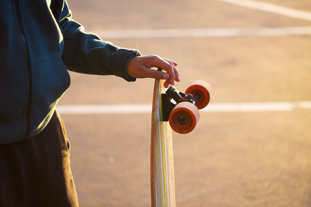 Teenager holding a longboard.の写真素材