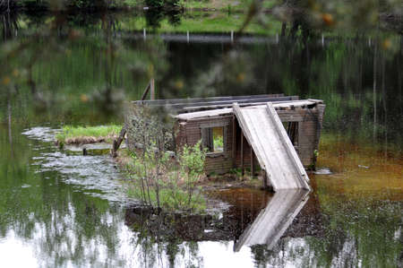 A wooden gazebo on the lakeの写真素材