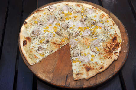 Italian pizza on a wooden tableの写真素材