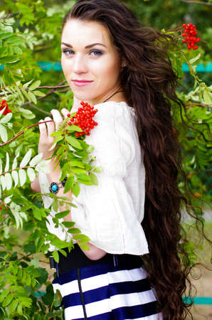 Beautiful girl with long dark hair near a mountain ashの写真素材