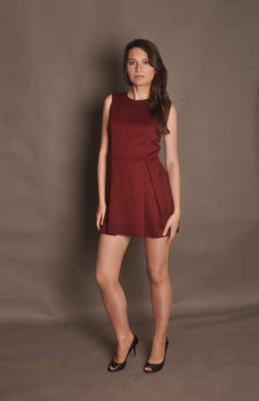 A slender girl in a fashionable red short dressの写真素材