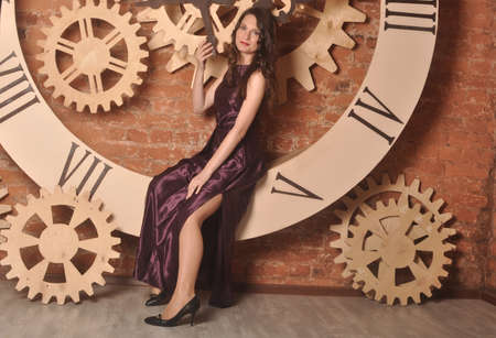 Girl in dress sitting on the dialの写真素材