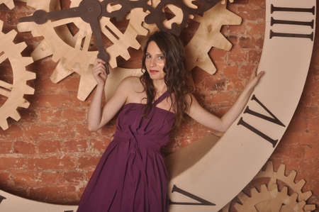 A girl in a lavender dress near the round dial watchの写真素材
