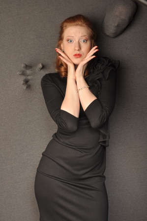 The girl in a black dress holding a palm near faceの写真素材