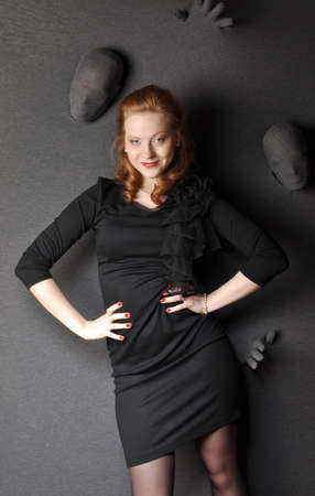 The girl in a black dress smilingの写真素材