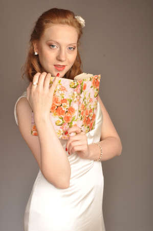 Portrait of red-haired girl with a book in their handsの写真素材