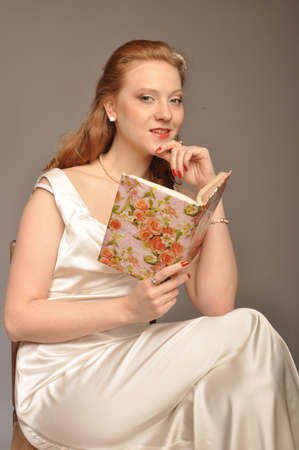 Portrait of red-haired stranger with a book in handの写真素材