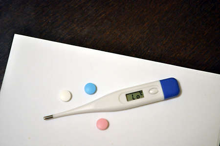Thermometer and colored tabletsの写真素材