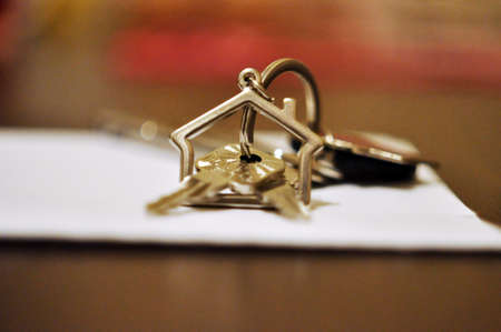 Keys on a keychain in the shape of a houseの写真素材
