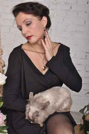 Girl with a rabbit in her handsの写真素材