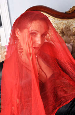 Girl in red veilの写真素材