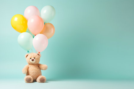 Beige fluffy bear kid toy with birthday balloon bunch in light pink yellow blue colours on minimal pastel background. Happy party celebration conceptの素材