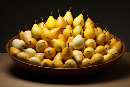 Delicious eco organic golden pear fruits in big bow on wooden table. Autumn harvest conceptの素材