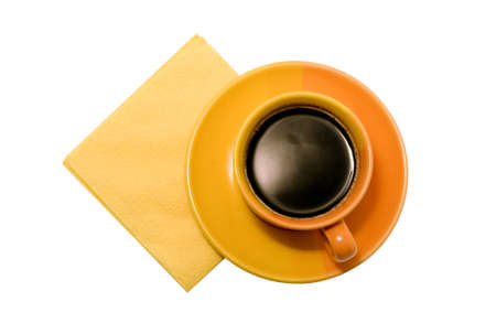Orange cup of coffee with a saucer and a napkinの写真素材