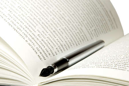 The pen on the book isolated on a white background