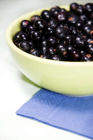 Black currant in a green bowl not isolatedの写真素材