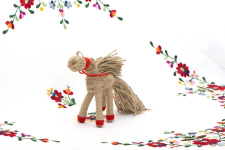 horse in tarditsionny style against the background of a color cloth