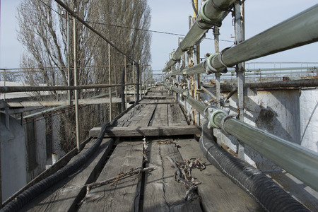on a platform the remains not of the rabotyushchy glass pipeline on which wine, with rusty capacities arrivedの写真素材