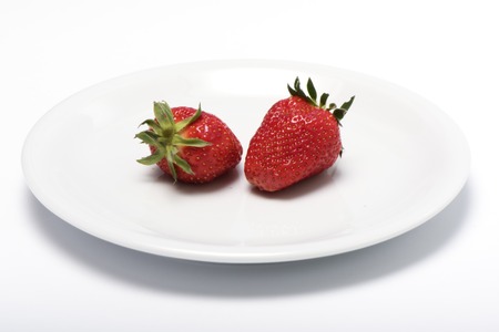 the whole strawberry on a plateの写真素材