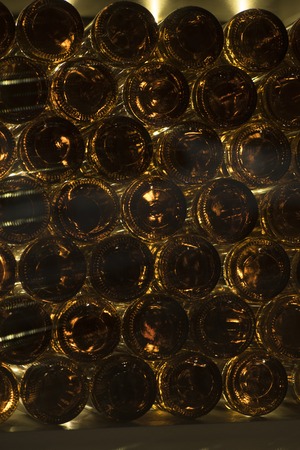 bottles of wine lie in a wine cellarの写真素材