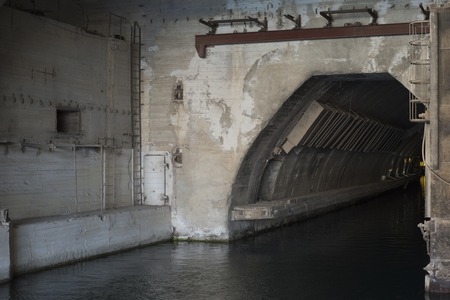 the entrance to the concrete bunker with the entrance from the water side. entry for shipsの写真素材